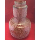 A large amber glass vase with mottled trailing style decoration, with tubular rim and moulded foot.