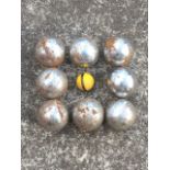 A set of cast iron boules, the heavy chromed balls with ring decoration, complete with golfball