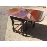 A late Victorian mahogany drop-leaf dining table, the moulded top with rounded corners to leaves,