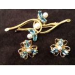 A gold suite with earrings and brooch, all set with oval aquamarines and seed pearls. (3)