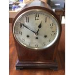 A large Edwardian domed mantleclock, the case with walnut panel framed by boxwood stringing above