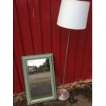 A painted rectangular mirror in cushion moulded frame; and a brushed aluminium standard lamp