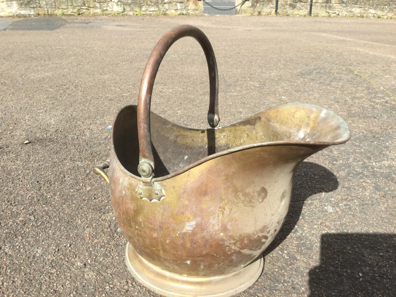 A brass helmet shaped coal skuttle with rolled rim and swing handle; and another similar smaller. ( - Image 2 of 3