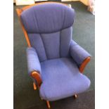 A Canadian Dutailer rocking chair with loose cushions and padded arms, the spindle frame with