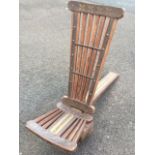 An unusual hardwood chair, the tapering back attached to a heavy drum with slats having iron & brass