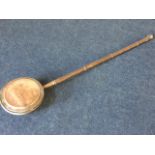 A Victorian bed warming pan with turned hardwood shaft mounted with copper pan, having moulded