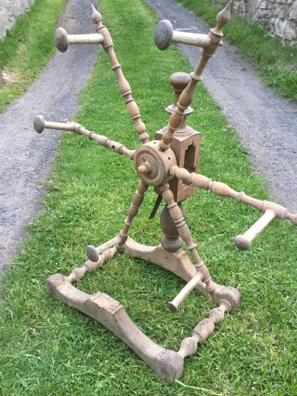 An antique woolwinder, the wheel with spindles around a hub, on turned column with shaped stand - - Image 2 of 3