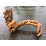 A chainsaw carved beech branch with three squirrels formed out of the solid, with scorched