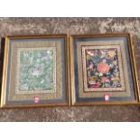 A pair of framed Chinese embroideries, the panels sewn in polychrome and blue & white with symbols -