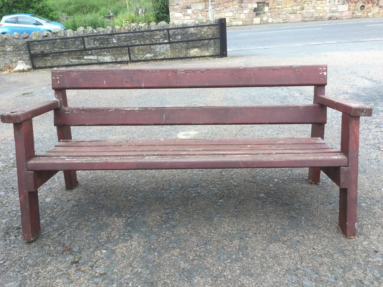 A rectangular garden bench of slatted construction, having platform arms and angled legs. - Image 2 of 3