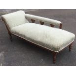 A late nineteenth century chaise longue, with sprung upholstered seat in reeded oak frame having