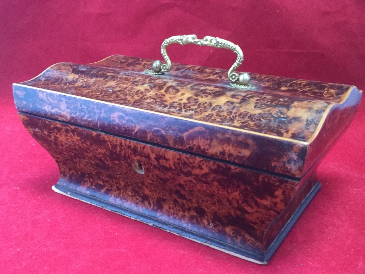 A Victorian partridge-wood jewellery casket, the waved lid mounted with ormolu snake handle,