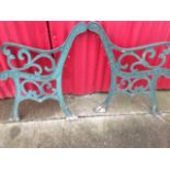 A pair of cast iron bench ends, with pierced scrolled decoration to chanelled frames