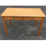 A beech writing table, with rectangular top above two frieze drawers mounted with brass cup handles