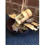 An indoor water feature with bamboo pipe & sticks mounted with stones