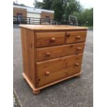 A Victorian style pine chest of drawers, the rounded moulded top above two short and two long