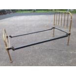 A Victorian brass bed with tubular grill head & tailboards in rounded frame