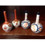 A pair of Japanese Imari spill vases decorated in the traditional brick-red & blue palette