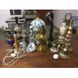 A Victorian brass oil lamp converted to electricity; and twelve other tablelamps including a pair,