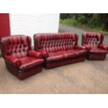 A leather three-piece chesterfield suite with button upholstery