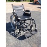 A Volant wheelchair with loose cushion and spoked wheels.