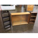 A small stained open bookshelf with four shelves and fretwork decoration