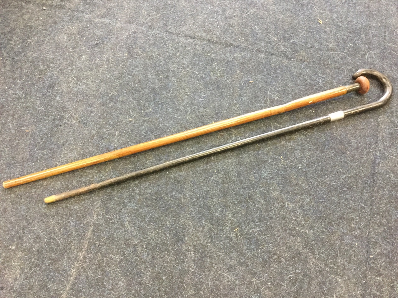 An ebonised walking stick with brass terminal, mounted with foliate engraved hallmarked silver