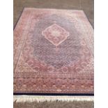 A Belgian oriental style Daimant carpet woven with busy blue field