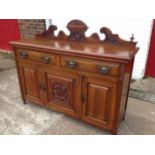 A carved late Victorian walnut sideboard