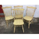 A set of four spindleback chairs, with saddle shaped seats on turned legs & stretchers. (4)