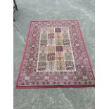 An Egyptian made oriental style rug, the field woven with twenty foliate stylised panels