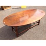 A large mahogany coffee table in the form of a reduced wake table