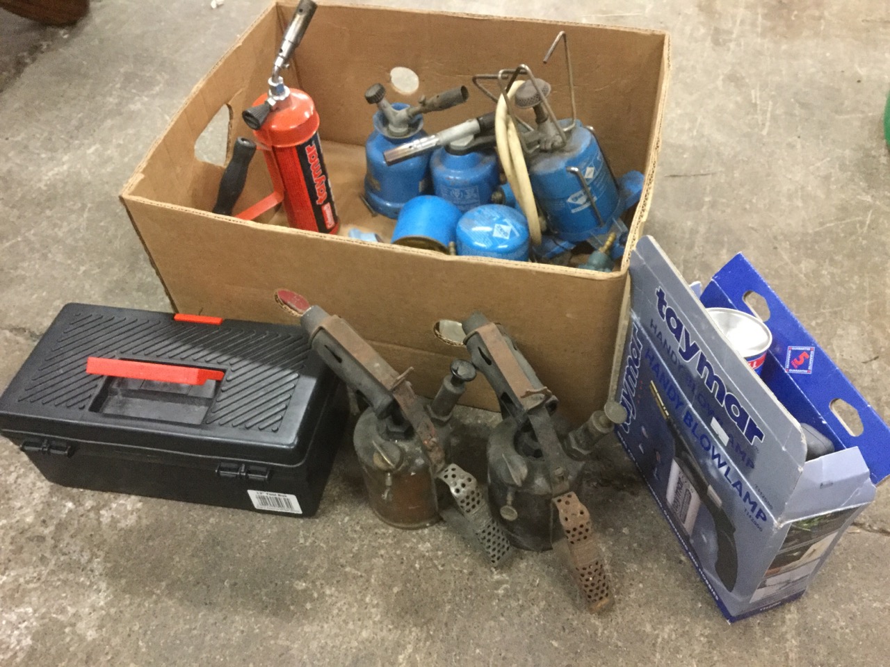 Various gas stoves, blowlamps, gas valves, etc; a small unused toolbox; and a pair of Primus