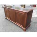 A mahogany sideboard with rectangular moulded top above a pair of fielded panelled doors