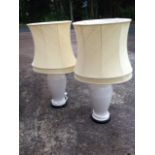 A pair of decorative crackle glaze tablelamps of baluster form raised on circular ebonised plinths,