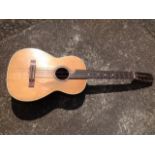 A classical guitar with cedar soundboard framed by inlaid trim