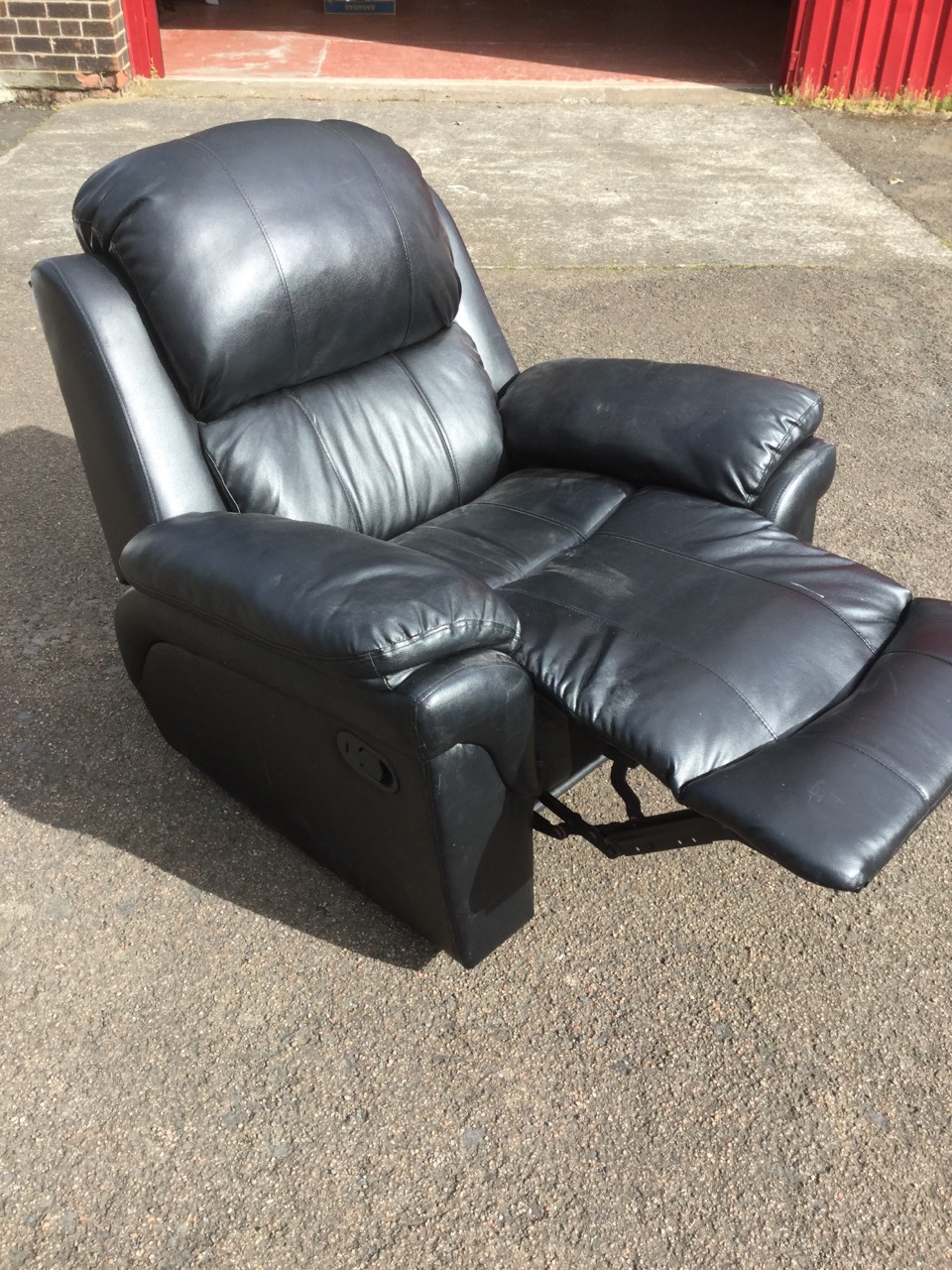 A contemporary leather reclining armchair, with padded back, arms and seat, complete with integral - Image 2 of 3