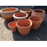 Seven terracotta garden pots, some with moulded and sgraffito decoration. (7)