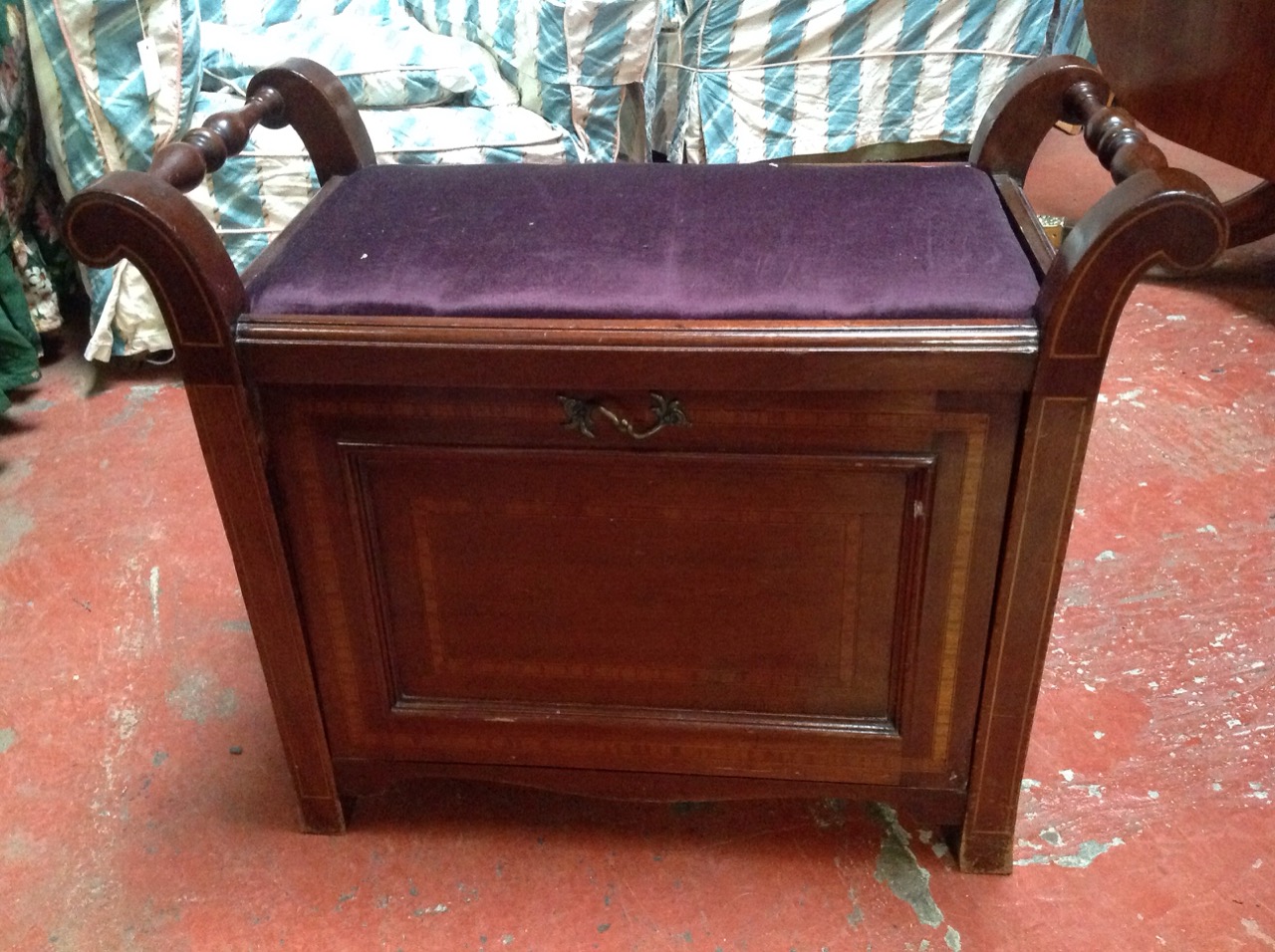 An Edwardian mahogany piano stool with rectangular upholstered seat