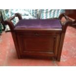 An Edwardian mahogany piano stool with rectangular upholstered seat