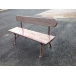 A garden bench with plank back & seat, on cast iron log cast ends with pad feet. (51in)