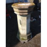 An octagonal composition stone column with moulded plinth, the platform top detachable.