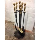 A modern fireside set, the brush, poker, shovel & tongs on stand with brass handles and knob finials