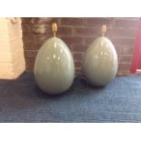 A pair of egg shaped celadon glazed tablelamps, with brass fittings - modern. (2)