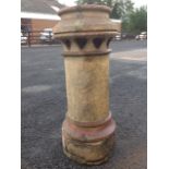 A stoneware chimney pot of tubular form, the rim pierced with heart shaped vents.