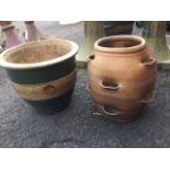 A stoneware salt glazed strawberry pot, the thrown vessel with pierced apertures; and a green glazed