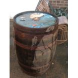 A 3ft oak whiskey barrel, the staves bound with six metal hoops.