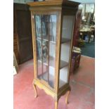 An Edwardian mahogany display cabinet with projecting moulded cornice