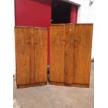 A pair of Shrager walnut bowfronted wardrobes