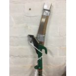 A Qualcast telescopic pruning saw with serrated blade and hook on extending pole.